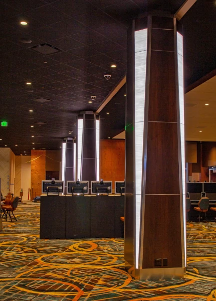 Pillars clad in custom LED lighting, wood, and stainless steel on the Auburn, WA, casino gaming floor.