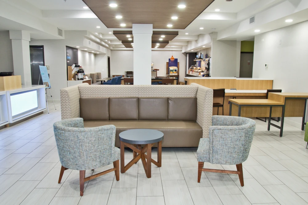 Renovated Tacoma hotel lobby with new tile floors, LED lighting, furniture, and dining by Seattle-area contractor Construction Expeditors.