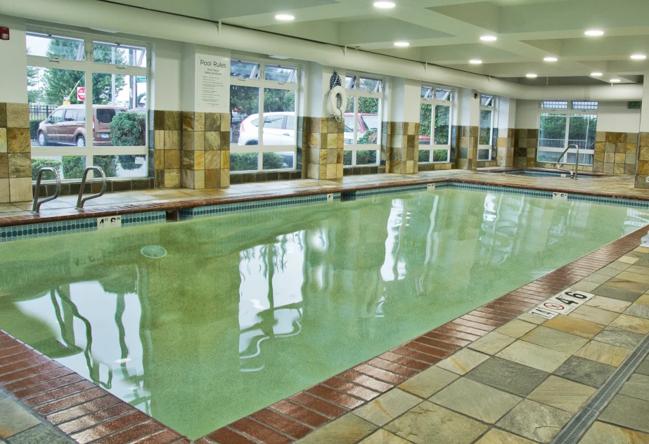 Holiday Inn Express Tacoma’s indoor pool with new tile on the pool deck and halfway up the walls.