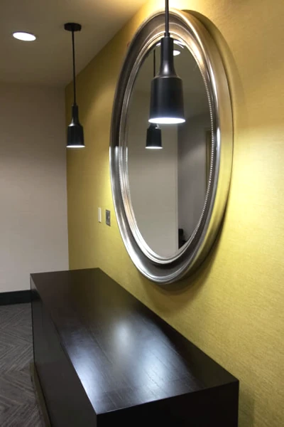 Renovated elevator lobby with new carpet, paint, wallpaper, and LED lighting by Construction Expeditors.