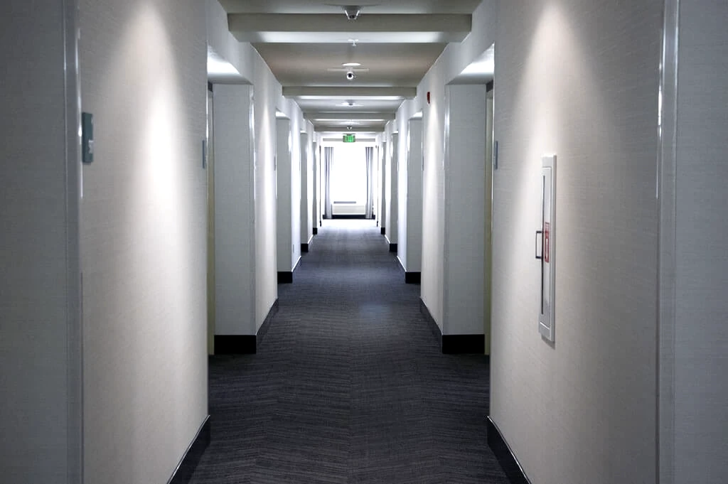 Renovated Holiday Inn Yakima hallway with new carpet, paint, wallpaper, and LED lighting.