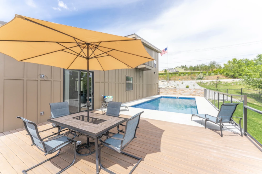 Balcony with outdoor dining area and pool.