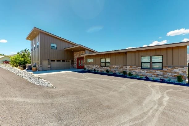 Front view of the new vacation home with attached garage and storage.