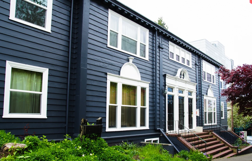 Renovated 1918 6-unit apartment building in Seattle with a new roof, paint, and windows.